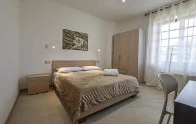 a bedroom with a large bed and a window at Villa Anastasia in Partinico