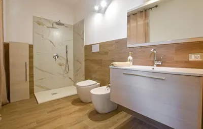 a bathroom with a toilet and a sink and a shower at Villa Anastasia in Partinico