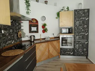 a kitchen with a black and white wallpaper at Sedie Volanti Classy Home in Palermo
