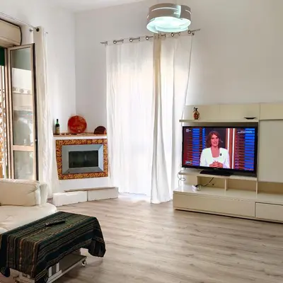 a living room with a flat screen tv in front of a window at Sedie Volanti Classy Home in Palermo