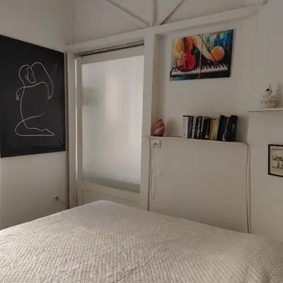 a bedroom with a bed and a sliding glass door at Sedie Volanti Classy Home in Palermo