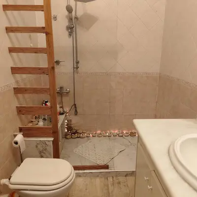 a bathroom with a shower with a toilet and a sink at Sedie Volanti Classy Home in Palermo