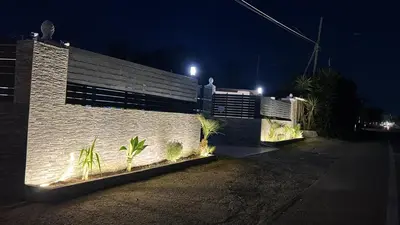 a brick building with plants in front of it at night at Relax Home in Ficarazzi