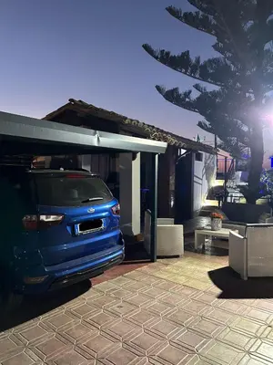 a blue van parked next to a building at Relax Home in Ficarazzi