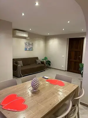 a living room with a table and a couch at Relax Home in Ficarazzi