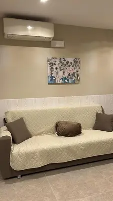 a large white couch sitting in a room at Relax Home in Ficarazzi