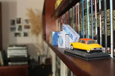 a toy car is sitting on a book shelf at Levriero1 in Carini