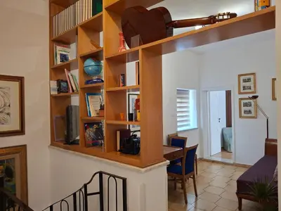 a living room with a desk and shelves at Levriero1 in Carini