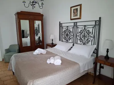 a bedroom with a bed with two towels on it at Levriero1 in Carini