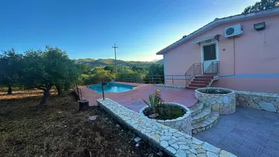 a house with a swimming pool next to a house at Villa con Piscina in Ventimiglia di Sicilia