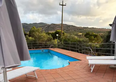 a swimming pool with a view of a mountain at Villa con Piscina in Ventimiglia di Sicilia