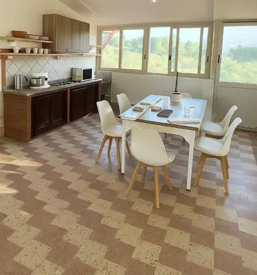 a kitchen with a table and chairs in a room at Villa con Piscina in Ventimiglia di Sicilia