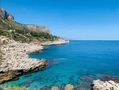 a view of the ocean from a rocky shore at Villino Rosa in Santa Flavia