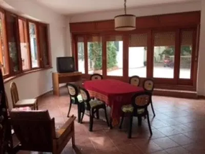 a dining room with a red table and chairs at Villino Rosa in Santa Flavia