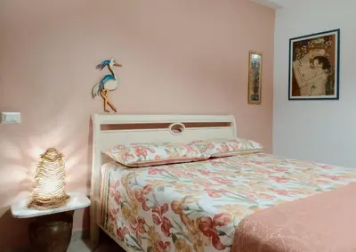 a bedroom with a bed and a lamp on a table at Sea View Holiday in Altavilla Milicia