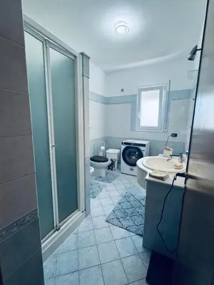 a bathroom with a shower and a toilet and a sink at Casa Nadiia in Cinisi