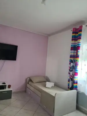 a small room with a bed and a tv at Casa Nadiia in Cinisi
