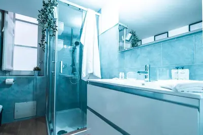 a bathroom with a glass shower and a sink at Marta's Home in Palermo