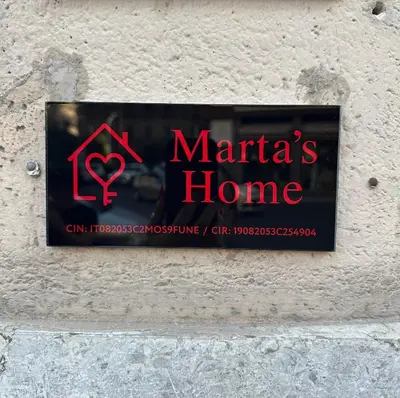 a sign for a marias home on a wall at Marta's Home in Palermo