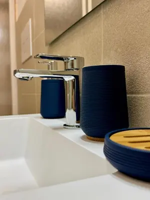 a bathroom sink with a faucet and a toilet paper holder at TerrAmata in Terrasini