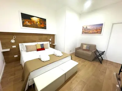 a bedroom with a bed and a chair in it at Suite 196 - Central City Palermo in Palermo