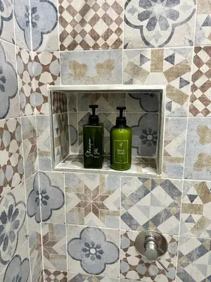 two green bottles sitting on a shelf in a bathroom at Suite 196 - Central City Palermo in Palermo