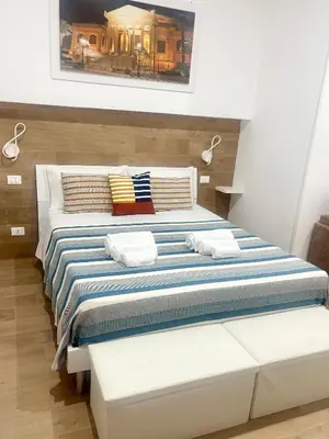 a bedroom with a large bed with two pillows at Suite 196 - Central City Palermo in Palermo