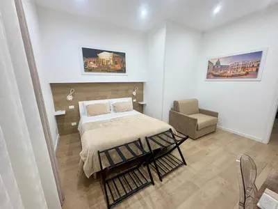 a bedroom with a bed and a chair in it at Suite 196 - Central City Palermo in Palermo