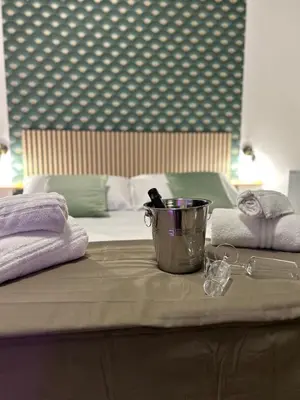 a table with a bucket on top of a bed at Florio Rooms in Palermo