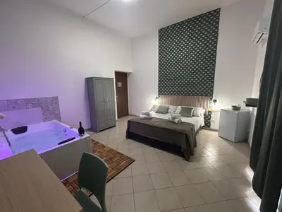 a living room with a tub and a couch at Florio Rooms in Palermo