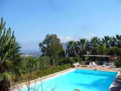 a swimming pool in a villa with palm trees at Giardino degli Ulivi in Palermo