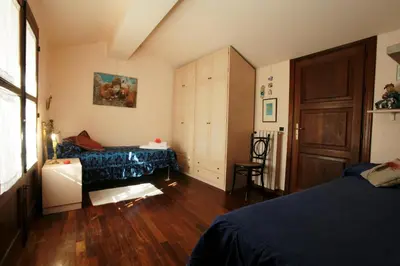 a bedroom with a bed and a table in it at Giardino degli Ulivi in Palermo
