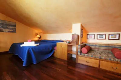 a room with a blue bed and a desk at Giardino degli Ulivi in Palermo