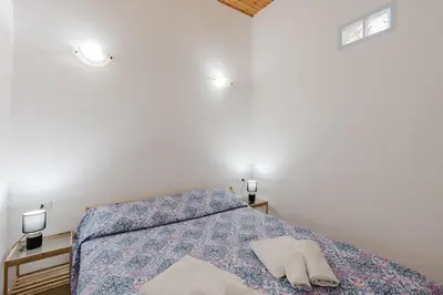 a bedroom with a bed with blue lights on it at Perla Marina in Trappeto