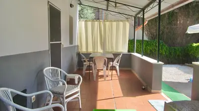 a patio with chairs and a table and a window at Da Sandra in Trabia