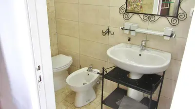 a bathroom with a sink and a toilet at Da Sandra in Trabia