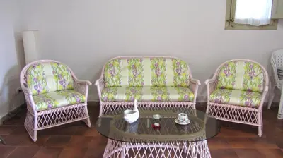 three chairs and a coffee table in a room at Da Sandra in Trabia