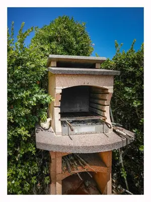 a bird sitting on top of a brick oven at Casetta mia Seaside in Buonfornello