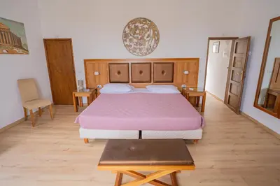 a bedroom with a bed with a purple bedspread at Himera Domus 2 in Termini Imerese