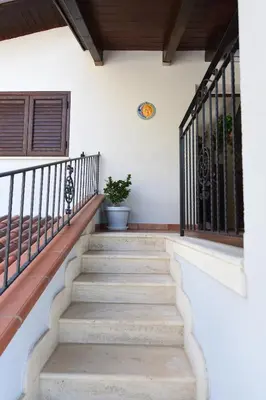 a staircase in a house with a plant at M&G Holiday House in Terrasini