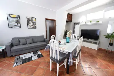 a living room with a table and a couch at M&G Holiday House in Terrasini
