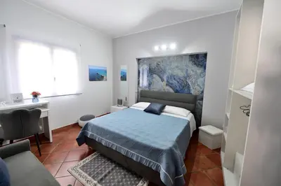 a small bedroom with a bed and a couch at M&G Holiday House in Terrasini