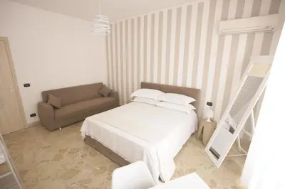 a small bedroom with a bed and a couch at Dream on the blue house Palermo in Palermo