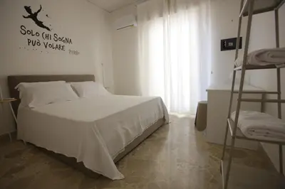 a bedroom with a bed and two bunk beds at Dream on the blue house Palermo in Palermo