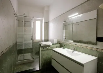 a bathroom with a sink and a shower and a mirror at Dream on the blue house Palermo in Palermo