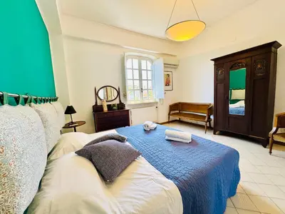 a bedroom with a bed and a green wall at Villa Crilulù al Mare in Palermo