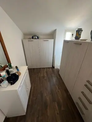 an empty room with three doors and wooden floors at Fantastic, sea view apartment via Duchessa in Castellammare del Golfo