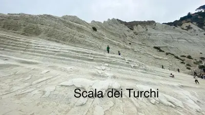 a group of people walking up a sand hill at Fantastic sea & harbour view Nino Bixio in Castellammare del Golfo
