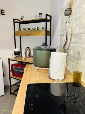 a kitchen with a counter with a pot on a table at Shamà rooms in Palermo