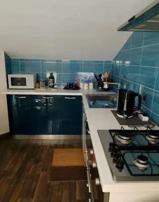 a kitchen with a stove and a counter top at Fantastic sea view Via Duchessa in Castellammare del Golfo